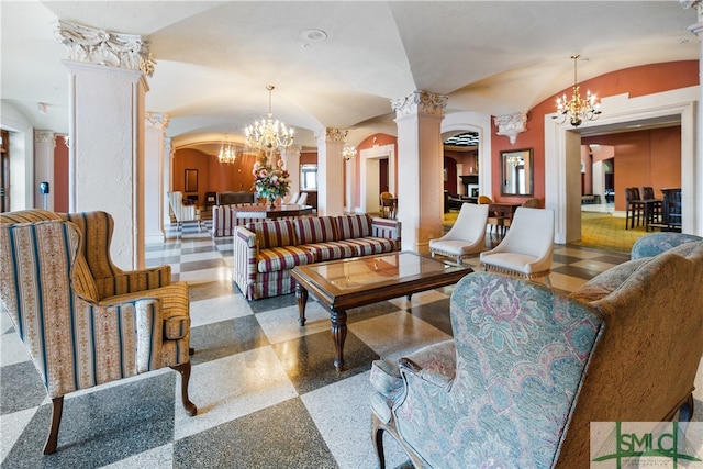 living room featuring lofted ceiling, a chandelier, and ornate columns