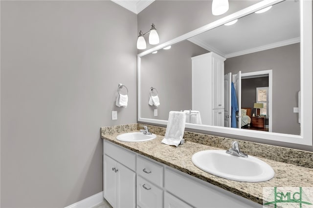 bathroom with ornamental molding and vanity