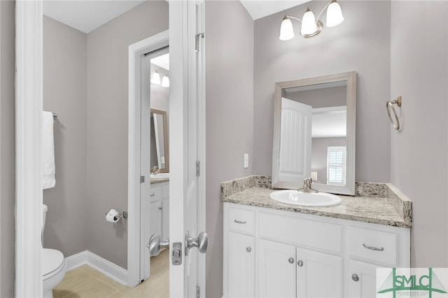 bathroom featuring vanity, tile patterned floors, and toilet