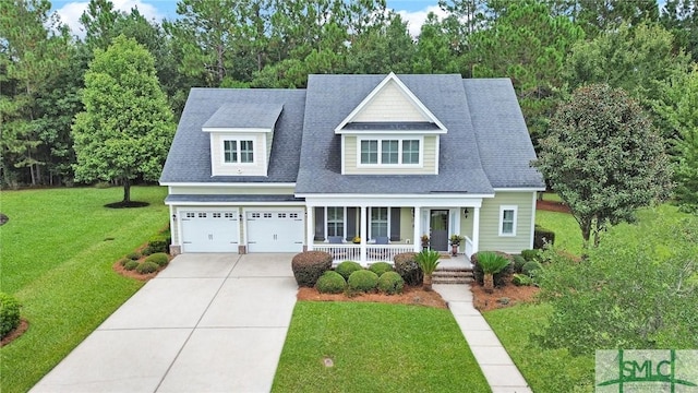 view of front facade with a garage, a front yard, and a porch