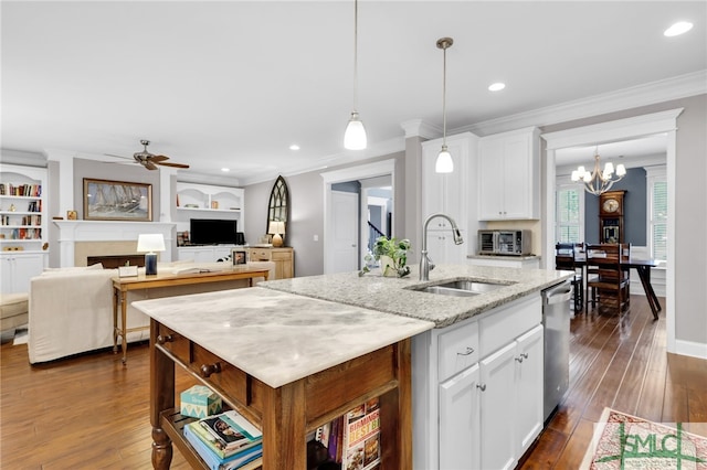 kitchen featuring dishwasher, sink, white cabinets, a kitchen island with sink, and light stone counters