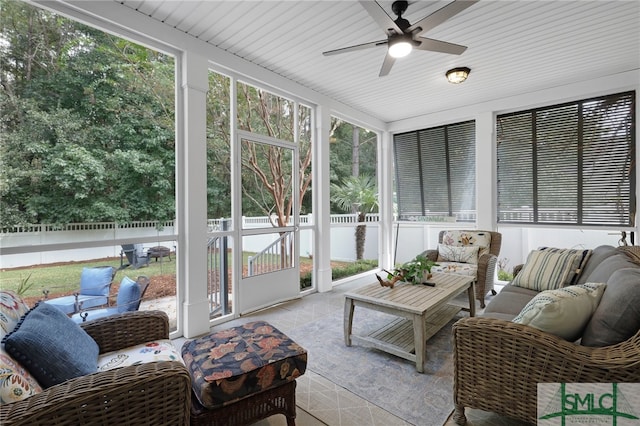 sunroom featuring ceiling fan and plenty of natural light