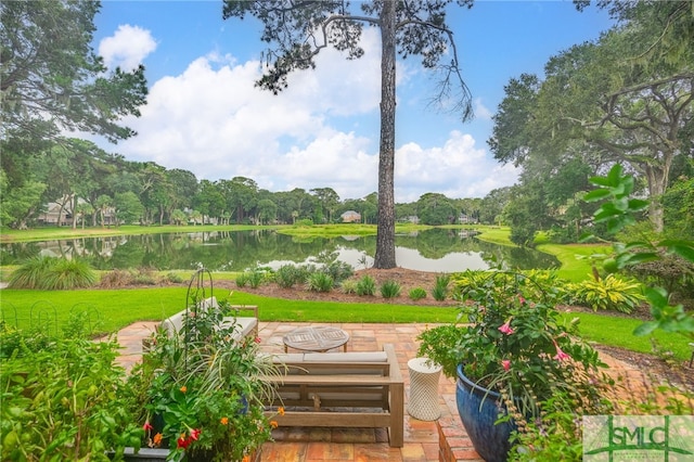 exterior space featuring a water view and a patio area