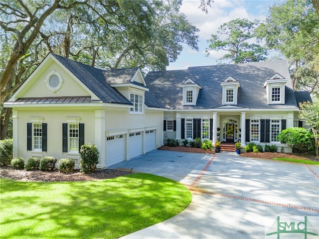 view of front of home with a garage, a porch, and a front lawn