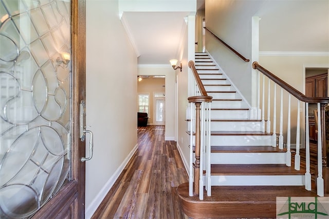 staircase with hardwood / wood-style flooring and crown molding