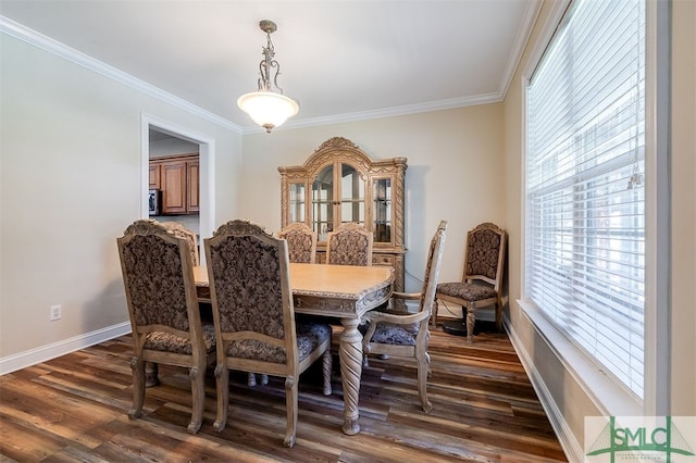 dining space with dark wood-type flooring and crown molding