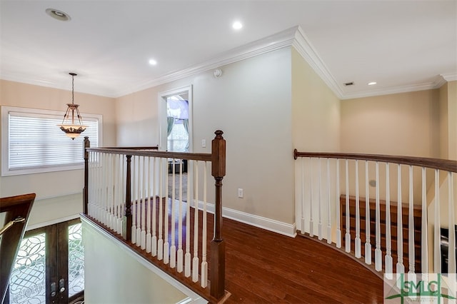 hallway with crown molding, dark hardwood / wood-style flooring, and a healthy amount of sunlight