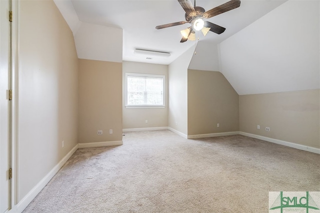 bonus room with lofted ceiling, ceiling fan, and light colored carpet