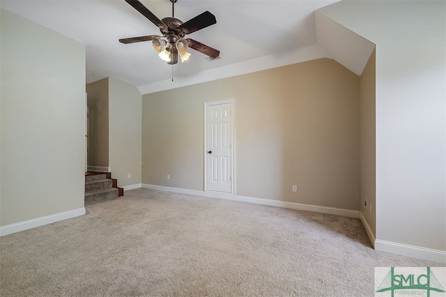 interior space with lofted ceiling, ceiling fan, and light colored carpet