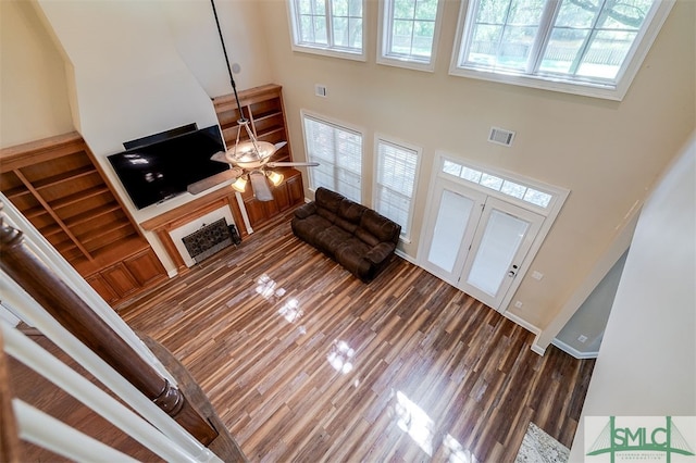 entryway with ceiling fan, dark hardwood / wood-style floors, and a high ceiling