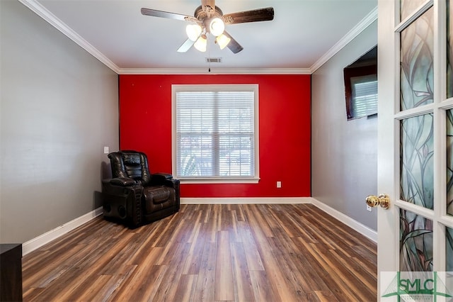 sitting room with ceiling fan, crown molding, and dark hardwood / wood-style flooring