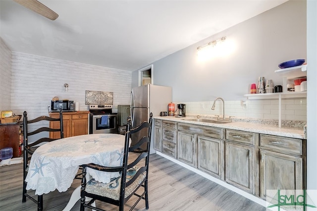 dining room with light hardwood / wood-style flooring and sink