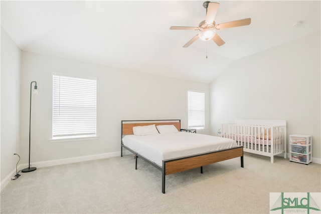 bedroom featuring ceiling fan, lofted ceiling, and light carpet