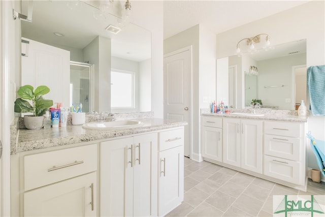 bathroom featuring walk in shower, vanity, and tile patterned floors