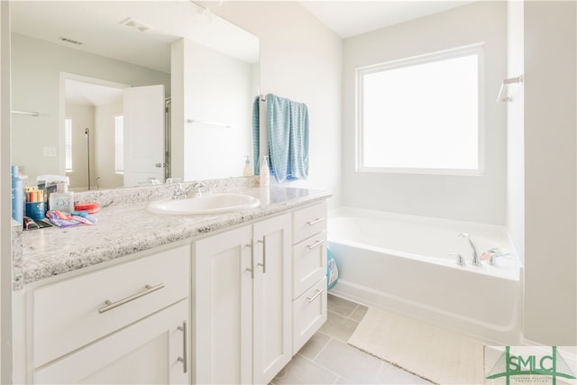 bathroom featuring shower with separate bathtub, vanity, and tile patterned floors