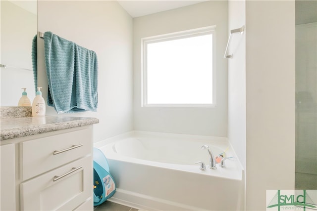 bathroom with a bath and vanity