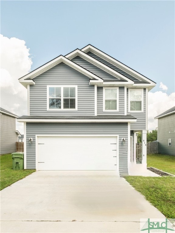 view of front of house featuring a front yard and a garage