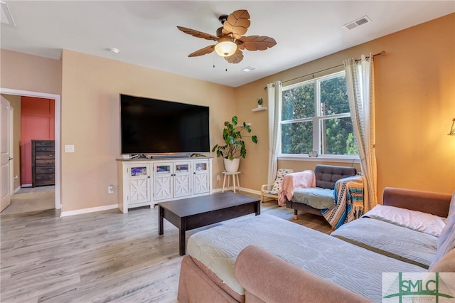 living room with ceiling fan and light wood-type flooring