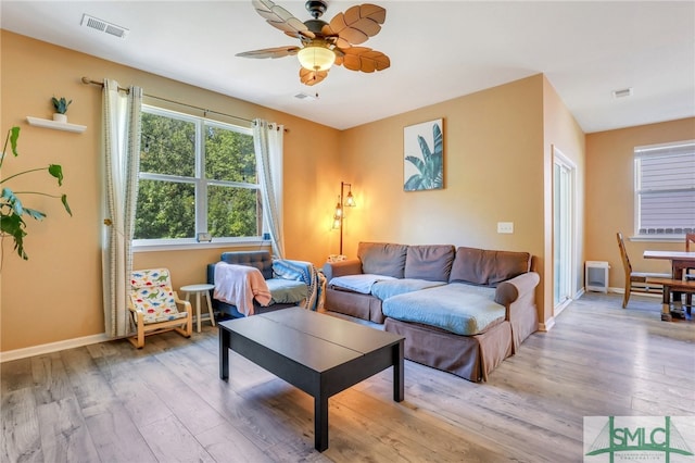 living room with light hardwood / wood-style floors and ceiling fan