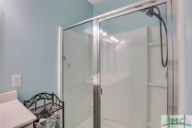 bathroom featuring vanity and a shower with door