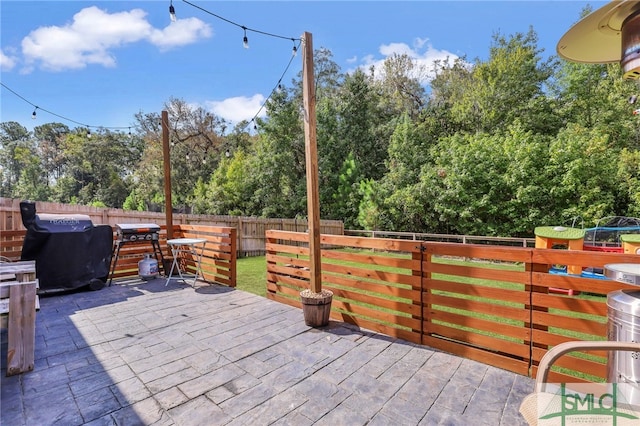 view of patio featuring a grill