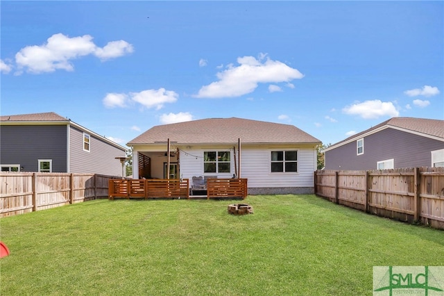 rear view of house with a yard