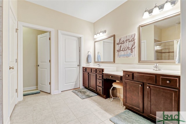 bathroom with vanity, tile patterned flooring, and a shower with door