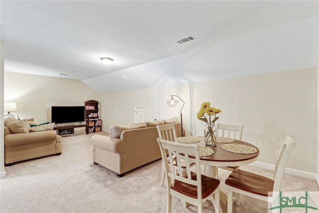 carpeted living room featuring vaulted ceiling