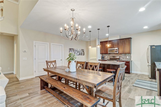 dining area featuring a chandelier and light hardwood / wood-style flooring