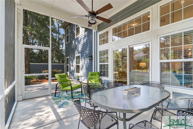 sunroom / solarium featuring ceiling fan