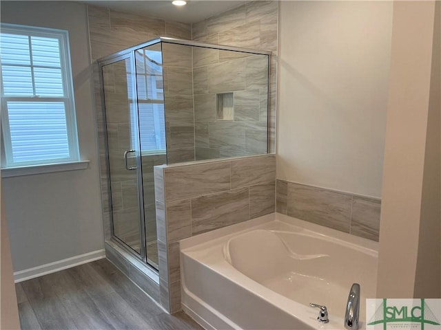 244 Brookline Dr, Savannah, GA 31407 - bathroom with a shower stall, baseboards, wood finished floors, and a bath