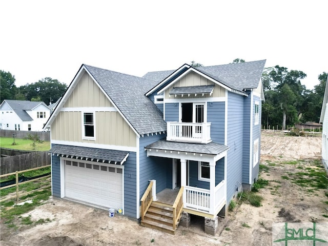 view of front of house featuring a balcony and a garage