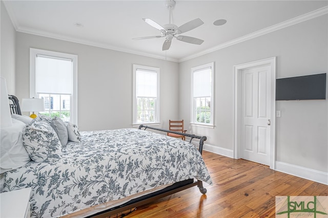 bedroom with ornamental molding, ceiling fan, and hardwood / wood-style flooring