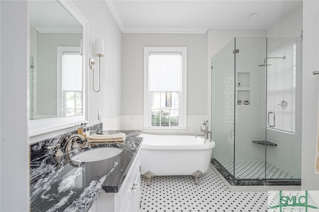 bathroom with vanity, crown molding, and separate shower and tub