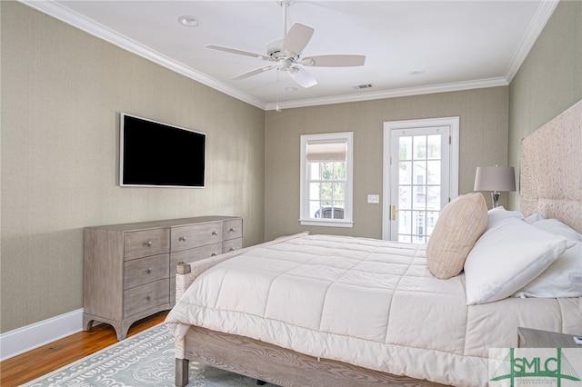 bedroom featuring ornamental molding, ceiling fan, and hardwood / wood-style floors