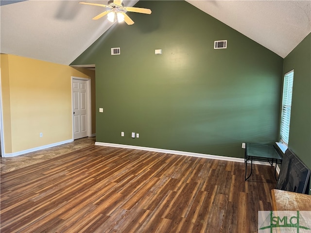 spare room featuring dark wood-type flooring, high vaulted ceiling, a textured ceiling, and ceiling fan