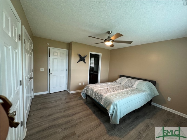 bedroom featuring ceiling fan, dark hardwood / wood-style floors, and a textured ceiling