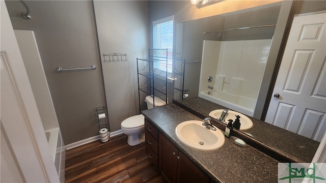 full bathroom with shower / bath combination, hardwood / wood-style flooring, toilet, and vanity