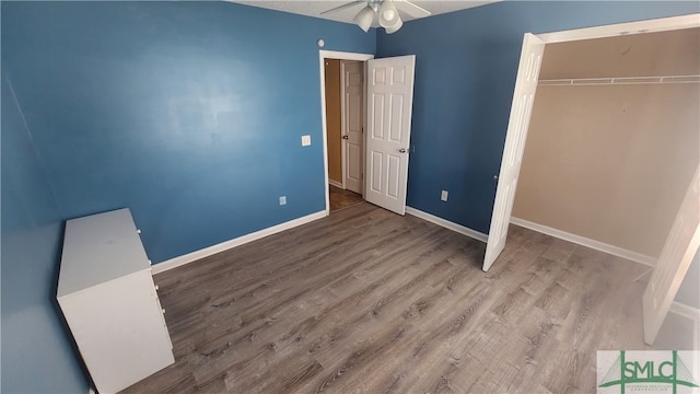 unfurnished bedroom featuring a closet, light hardwood / wood-style floors, and ceiling fan