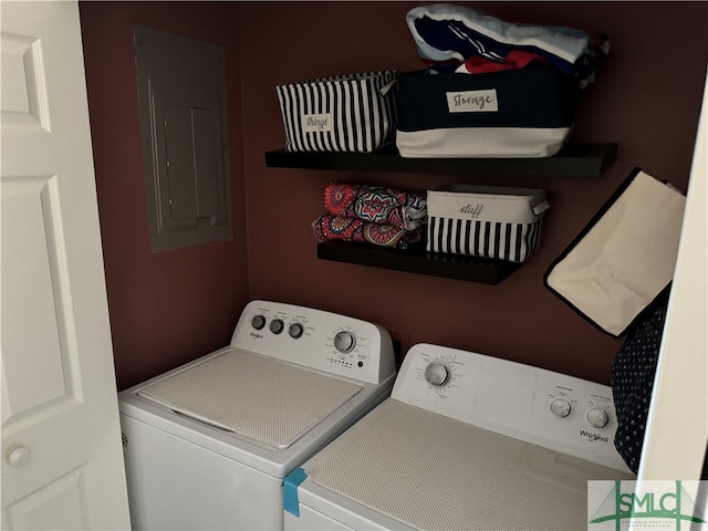 clothes washing area with washing machine and dryer and electric panel