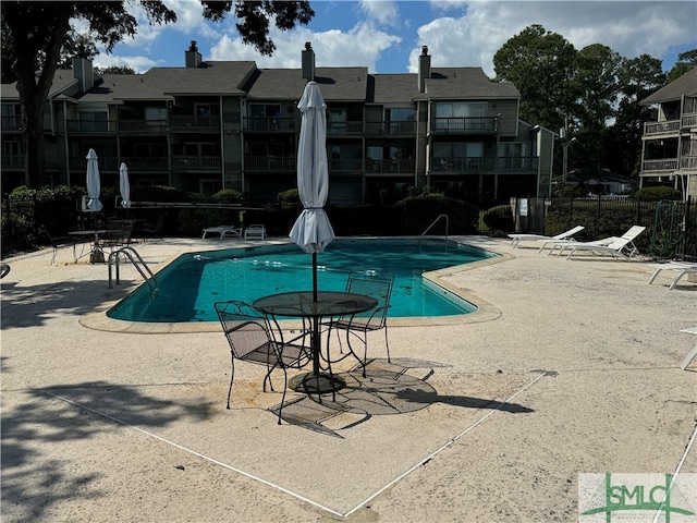 view of swimming pool with a patio