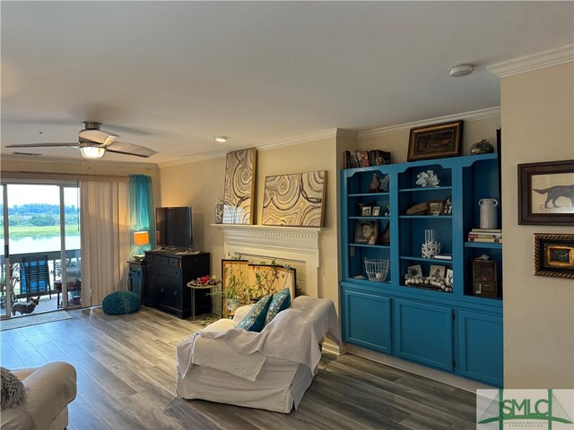 living room with hardwood / wood-style floors, ceiling fan, and crown molding