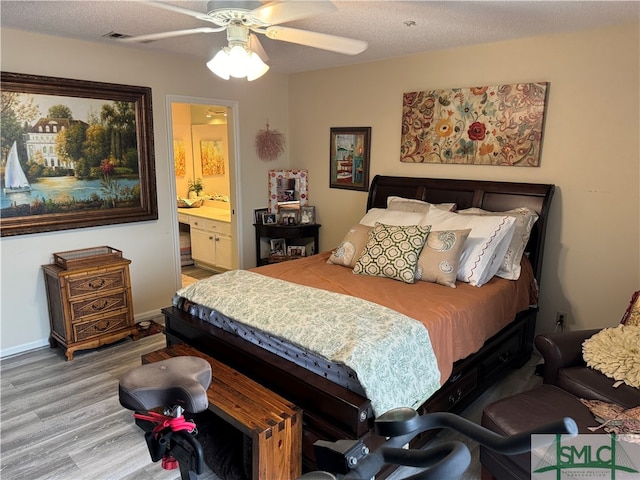 bedroom with ensuite bath, ceiling fan, hardwood / wood-style floors, and a textured ceiling