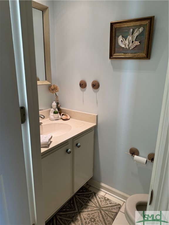 bathroom with tile patterned floors, vanity, and toilet