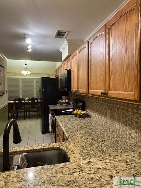 kitchen featuring light stone countertops, sink, electric range oven, crown molding, and light tile patterned floors