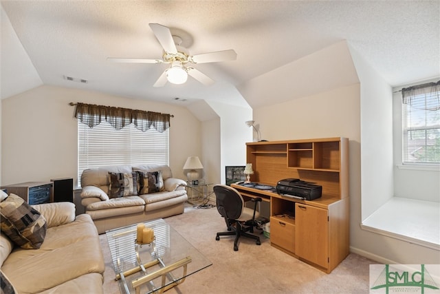 carpeted home office featuring ceiling fan, a textured ceiling, and lofted ceiling