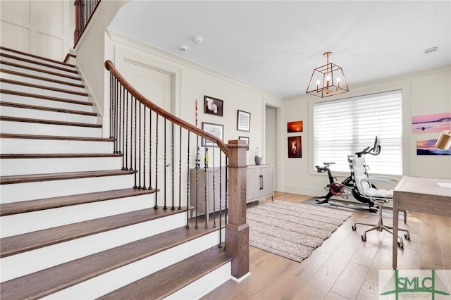 office space with a chandelier, light hardwood / wood-style floors, and crown molding