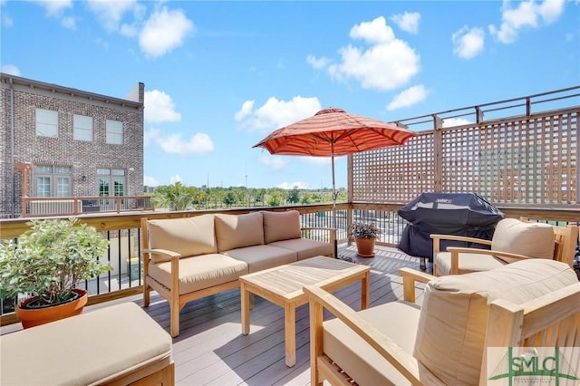 wooden terrace with outdoor lounge area and a grill