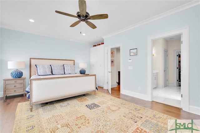 bedroom with hardwood / wood-style flooring, ceiling fan, crown molding, and ensuite bathroom