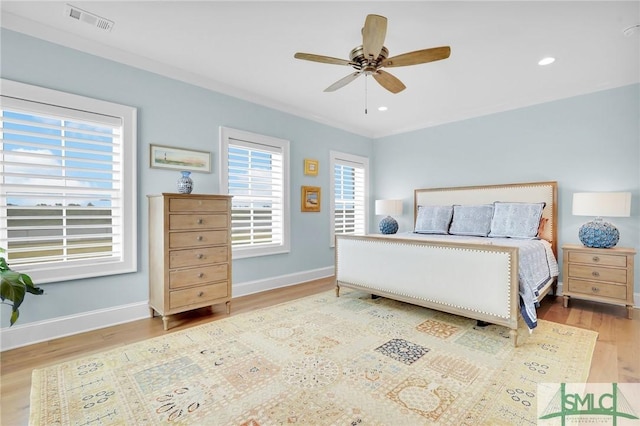 bedroom with ceiling fan, light wood-type flooring, and ornamental molding